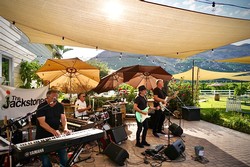 The Jackstones performing live music on a patio